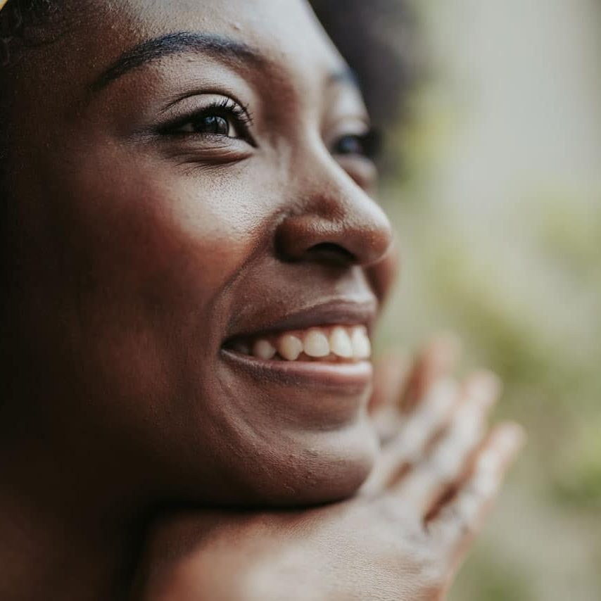 Cropped photo of young American girl enjoying time while smiling to somebody. Focus on female face; Shutterstock ID 1401390065; purchase_order: -; job: -; client: -; other: -